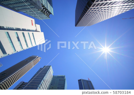 Skyscrapers in front of Hamamatsu Station such as the World Trade Center Building (top right of the screen) in Tokyo cityscape in Japan (blue sky over typhoon) 58703184