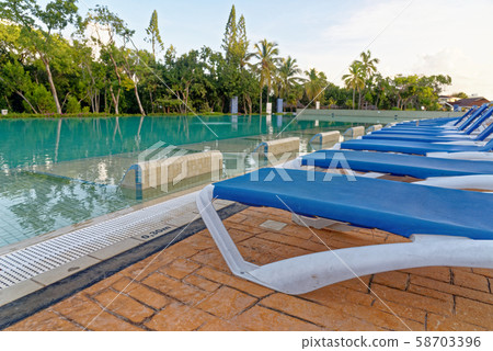 Beach chairs near swimming pool 58703396