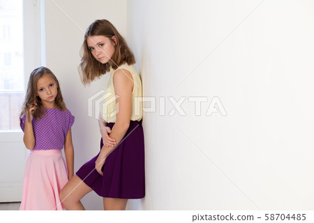 Two fashionable little sister girls of different ages Two fashionable little sister girls of different ages 58704485