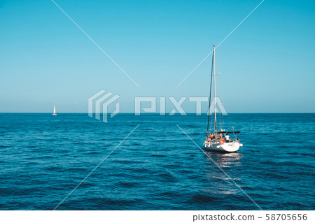 sailing boat with group of people on calm ocean on sailing boat with group of people on calm ocean on 58705656