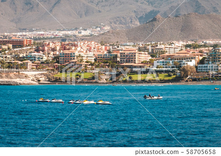 group of jet ski in ocean with hotels at coast group of jet ski in ocean with hotels at coast 58705658