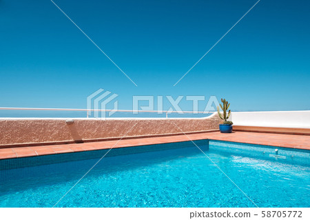 outdoor swimming pool with clear blue sky 58705772