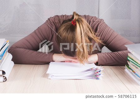 Tired freelance worker sleeping on workdesk Tired freelance worker sleeping on workdesk 58706115