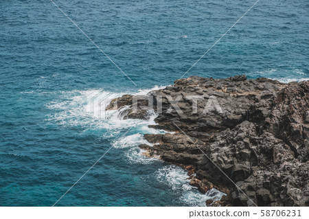 black rock in surf of ocean shore - rocky coast black rock in surf of ocean shore - rocky coast 58706231