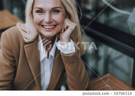 Happy pretty woman is looking ar camera Happy pretty woman is looking ar camera 58706318