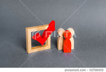 People figurines stand near the checkbox for voting in democratic elections. Lobbying interests, voter bribery, and rigging presidency or parliamentary election results. expression of will People figurines stand near the checkbox for voting in democratic elections. Lobbying interests, voter bribery, and rigging presidency or parliamentary election results. expression of will 58706950