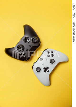 White and black two joystick on yellow background. 58707289