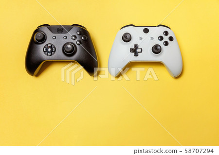 White and black two joystick on yellow background. White and black two joystick on yellow background. 58707294