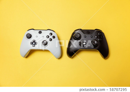 White and black two joystick on yellow background. 58707295