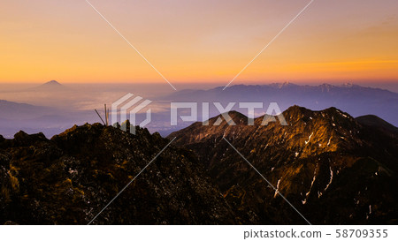 Spring Yatsugatake mountain climbing: Dawn at the summit of Mt. Akadake (Fuji, Southern Alps distant view) 58709355
