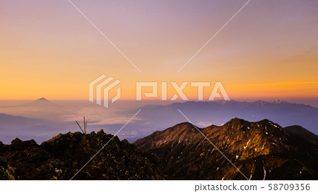 Spring Yatsugatake mountain climbing: Dawn at the summit of Mt. Akadake (Fuji, Southern Alps distant view) 58709356