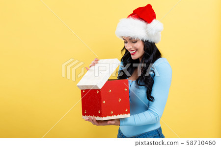 Young woman opening a Christmas gift box 58710460