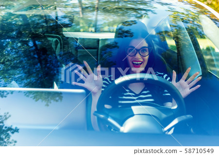 Woman in an autonomous vehicle 58710549