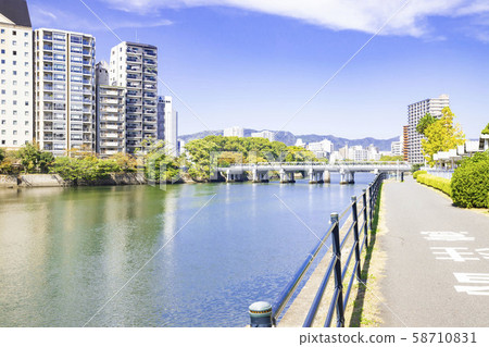 Blue sky and cityscape along the river 58710831