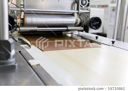 chocolate wafer pouring at a confectionery factory 58710862