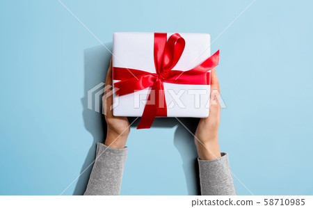 Person holding a Christmast gift box 58710985