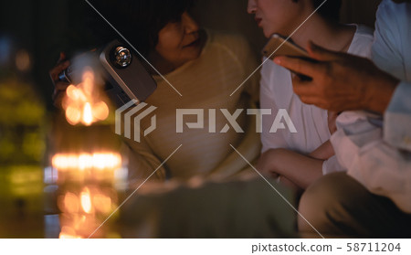 Family waiting for a typhoon in a blackout room 58711204