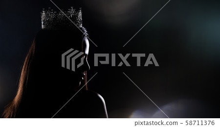 Portrait of Miss Pageant Beauty Contest in sequin Evening Ball Gown long dress with sparkle light Diamond Crown, silhouette low key exposure with curtain, studio lighting dark background dramatic Portrait of Miss Pageant Beauty Contest in sequin Evening Ball Gown long dress with sparkle light Diamond Crown, silhouette low key exposure with curtain, studio lighting dark background dramatic 58711376