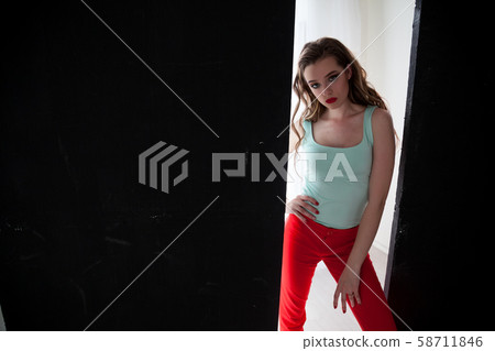 Portrait of a beautiful woman with long hair sitting on the floor Portrait of a beautiful woman with long hair sitting on the floor 58711846