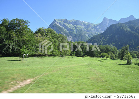 Greghorn behind a meadow in Heidiland Greghorn behind a meadow in Heidiland 58712562