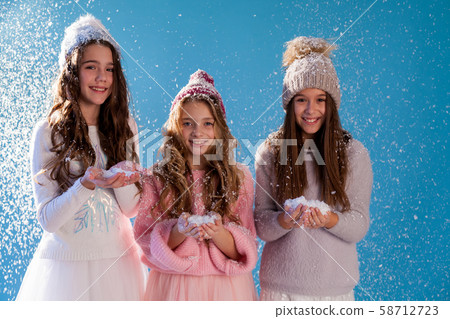 Three girl girlfriends play with snow in winter 58712723