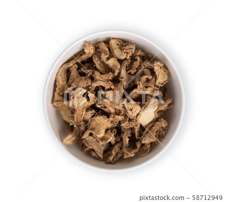 dried ginger in the white bowl isolated on white 58712949