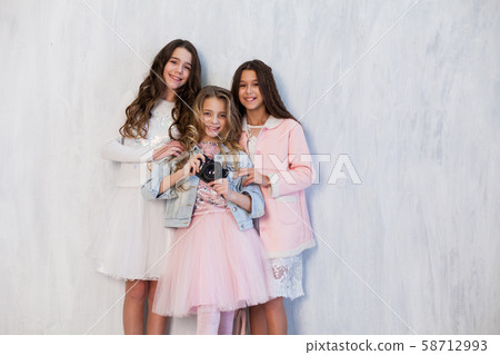 Three beautiful girls with a camera at a photo shoot 58712993