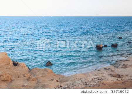 yellow warm sand and summer sea with sky and free space. Tropical beach scenery background with 58716082