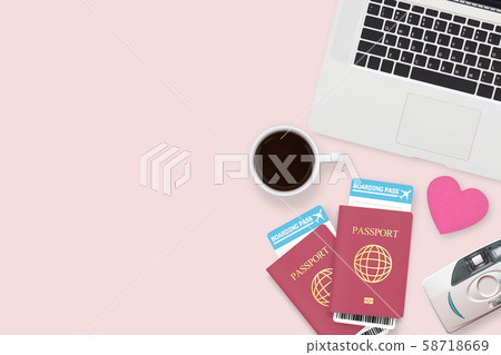 flat lay of red heart on two passport , coffee , computer laptop and copy space on pink pastel background. travel , honeymoon and vacation concept flat lay of red heart on two passport , coffee , computer laptop and copy space on pink pastel background. travel , honeymoon and vacation concept 58718669