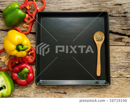 flat lay of empty blank black plate with wooden spoon and utensils with herbs and colorful bell pepper over wooden background. top view with copy space. food recipe and cooking concept flat lay of empty blank black plate with wooden spoon and utensils with herbs and colorful bell pepper over wooden background. top view with copy space. food recipe and cooking concept 58719198