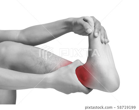 man suffering from cramp using hand massage painful foot and ankle. mono tone color with red highlight at ankle , ankle muscles isolated on white background. health care ,medical concept. studio shot man suffering from cramp using hand massage painful foot and ankle. mono tone color with red highlight at ankle , ankle muscles isolated on white background. health care ,medical concept. studio shot 58719199