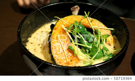 Close-up images of yellow color soup curry with chicken, pork and vegetable in bowl which famous traditional food menu and only found in Hokkaido Sapporo district of Japan Close-up images of yellow color soup curry with chicken, pork and vegetable in bowl which famous traditional food menu and only found in Hokkaido Sapporo district of Japan 58719364