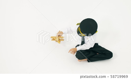 Boy wearing pilot's uniform plays with toy plane. Aircraft landing Boy wearing pilot's uniform plays with toy plane. Aircraft landing 58719969