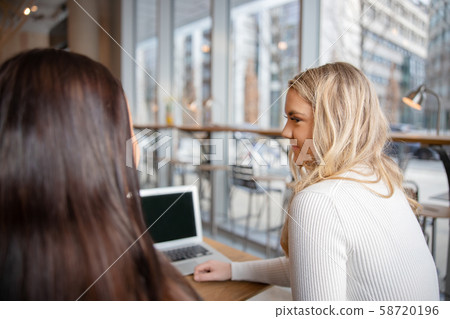 Close-up real students work on school project at modern coffee shop Close-up real students work on school project at modern coffee shop 58720196