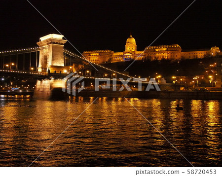 Illuminated Szechenyi Chain Bridge and Buda Castle from the Danube River, Hungary 58720453