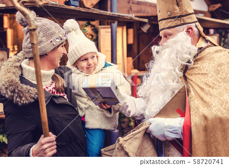 St Nikolaus and a family on the Christmas market St Nikolaus and a family on the Christmas market 58720741