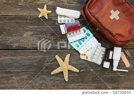 First aid kit on old wooden background. Concept of 58720834