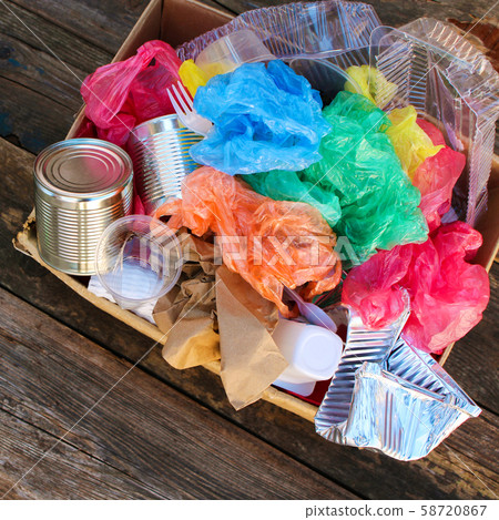 Box with trash on wooden background. 58720867