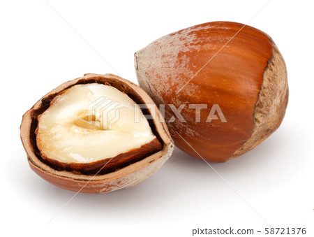 Half and whole hazelnuts isolated on white Half and whole hazelnuts isolated on white 58721376