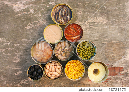 Different open canned food on old wooden 58721575