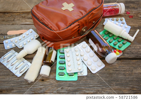 First aid kit on old wooden background. 58721586