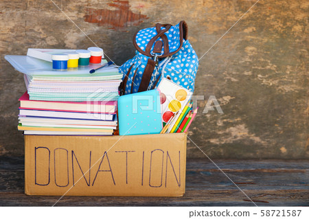 Donation box with school supplies on old wooden Donation box with school supplies on old wooden 58721587