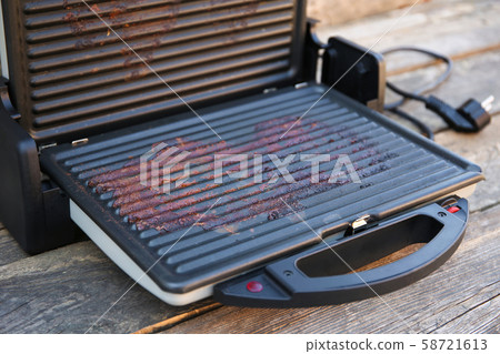 Dirty electric grill on old wooden background. Top Dirty electric grill on old wooden background. Top 58721613