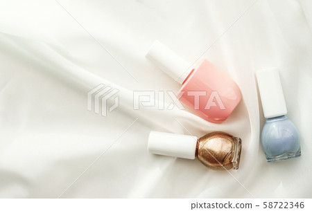 Nail polish bottles on silk background, french 58722346
