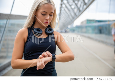 Woman Checking Heart Rate Using Smartwatch After Workout On Brid Woman Checking Heart Rate Using Smartwatch After Workout On Brid 58722789