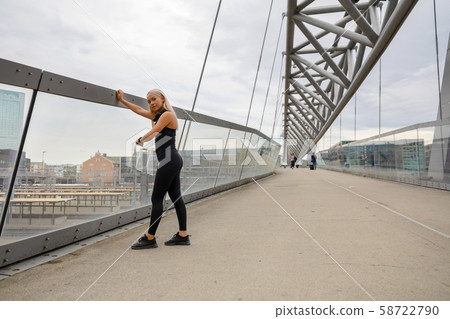 Woman Checking Heart Rate Using Smartwatch After Workout On Bridge 58722790