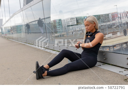 Runner On Bridge Checks Workout Performance Results After Running Runner On Bridge Checks Workout Performance Results After Running 58722791