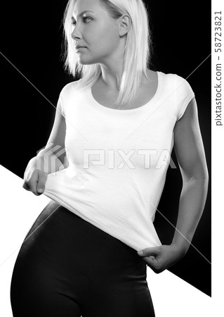 Black and white split portrait of woman standing in studio Black and white split portrait of woman standing in studio 58723821