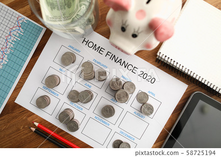 Top view of coin tover with paper calendar against Top view of coin tover with paper calendar against 58725194