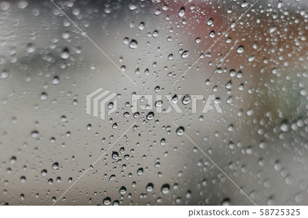 Blurred rainy window with red bokeh light 58725325